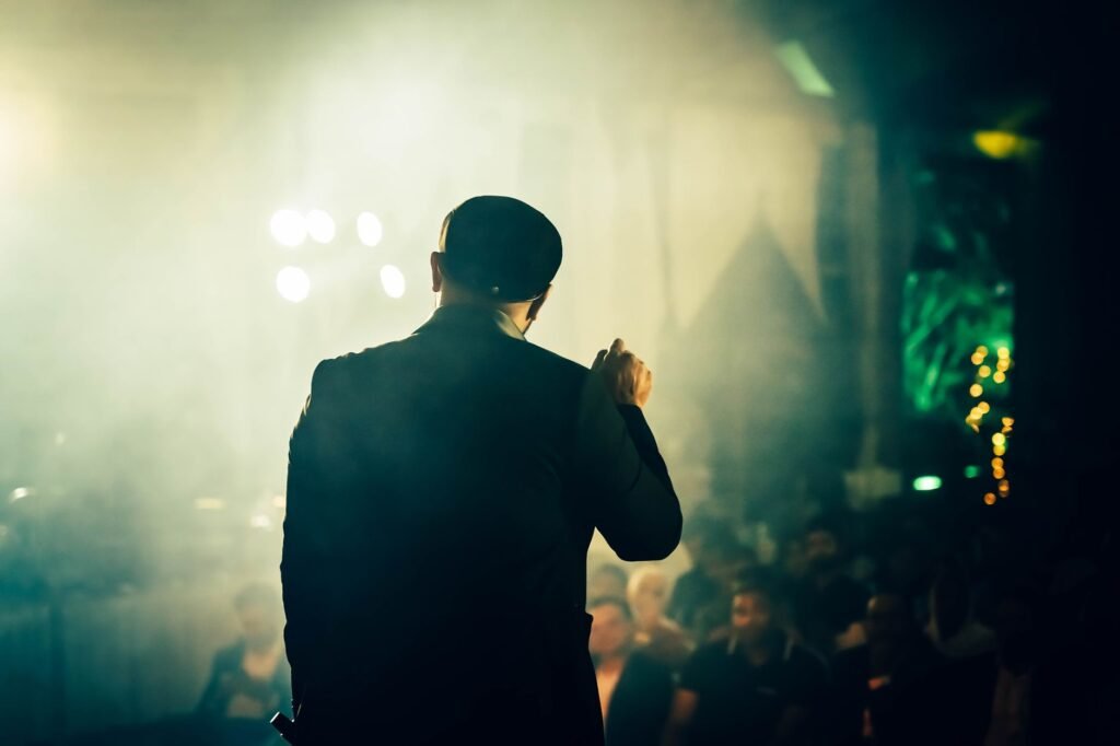 Adult leaving a well-lit venue with a phone in the evening