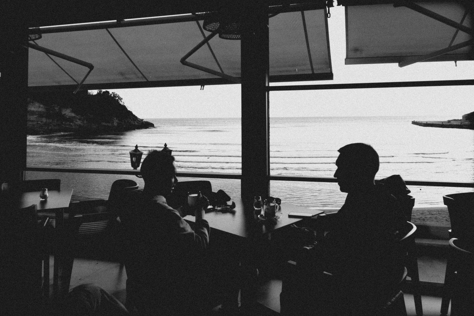 Adult person having a quiet conversation in a discreet seaside café