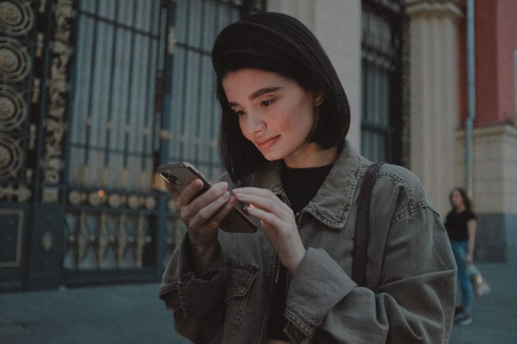 Adult traveller checking a phone in a safe public setting
