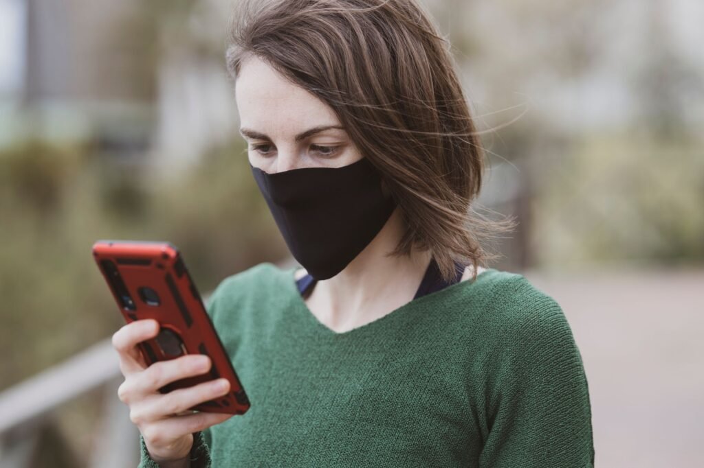 Adult checking a phone during a planned public meeting in Hull
