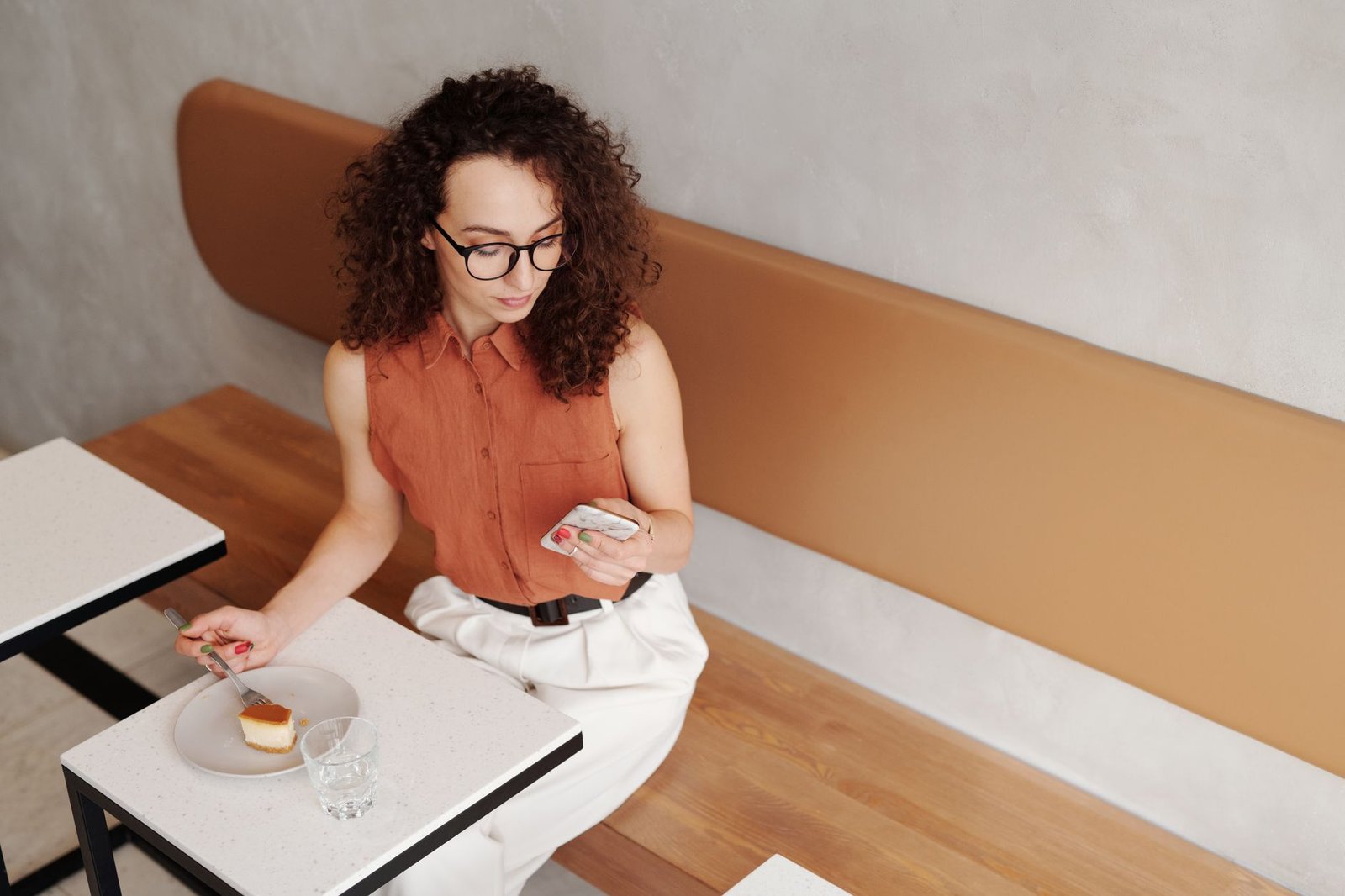 Adult woman reviewing messages at a cafe in Reading