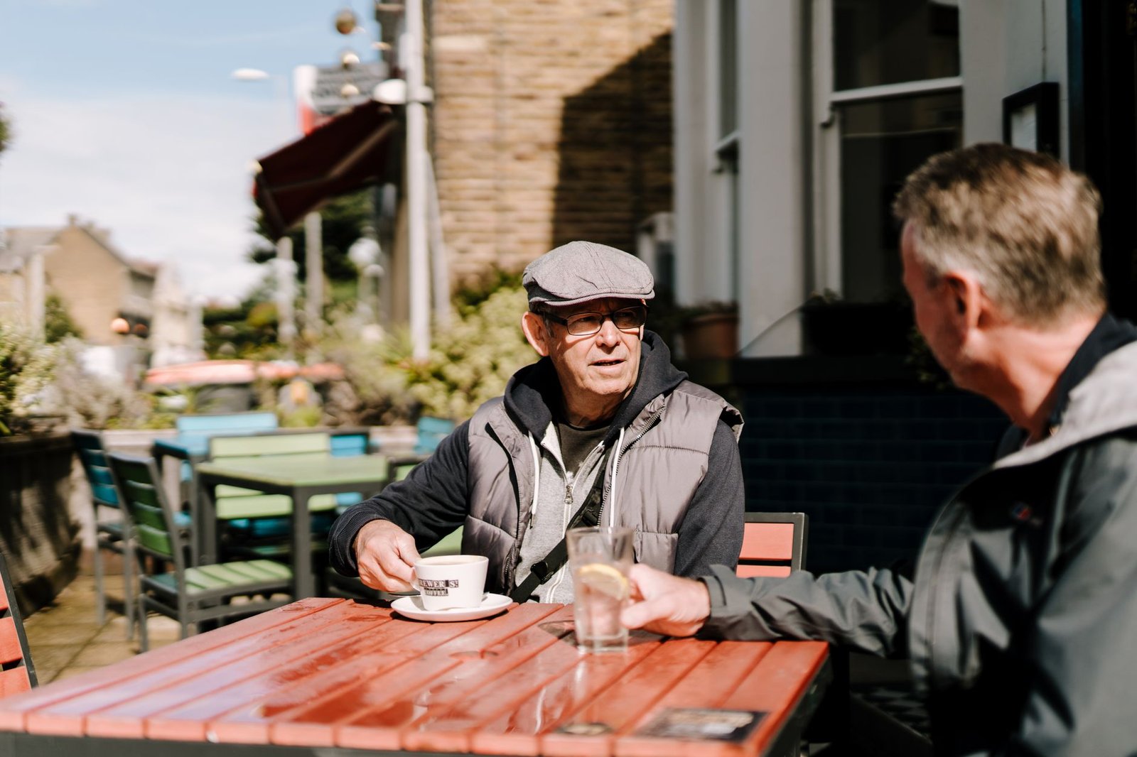 Two adults having a respectful conversation in a café