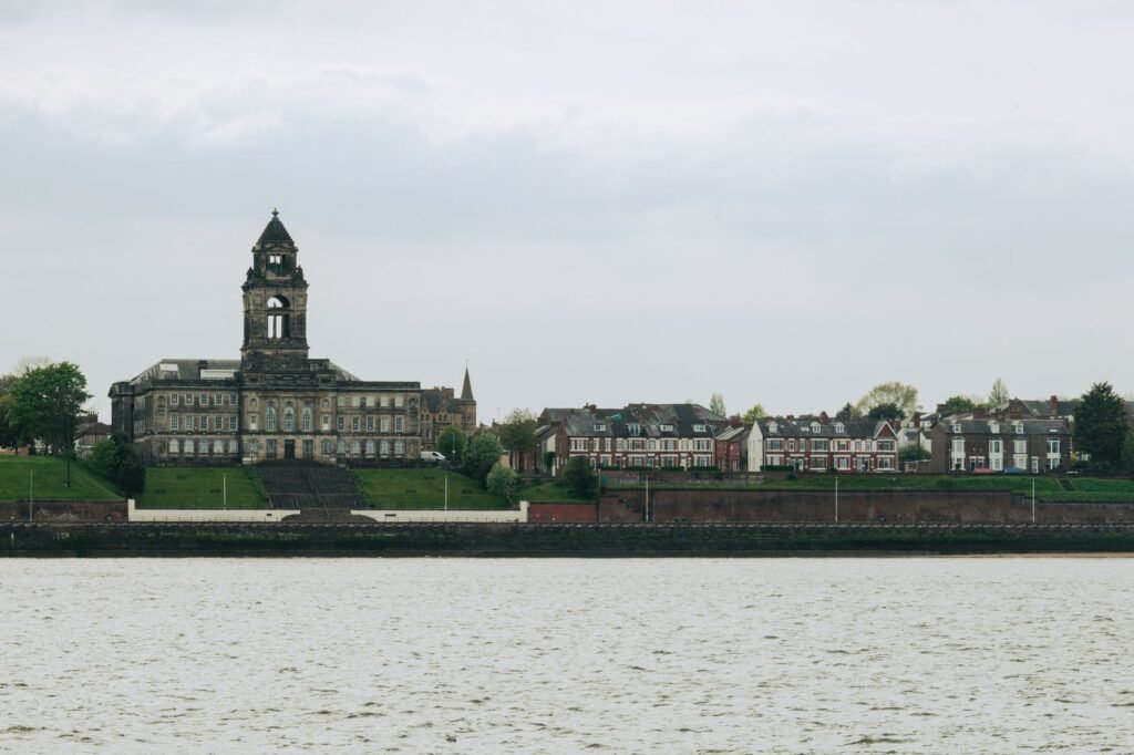 Wallasey Town Hall and surrounding buildings viewed across Liverpool's River Mersey.