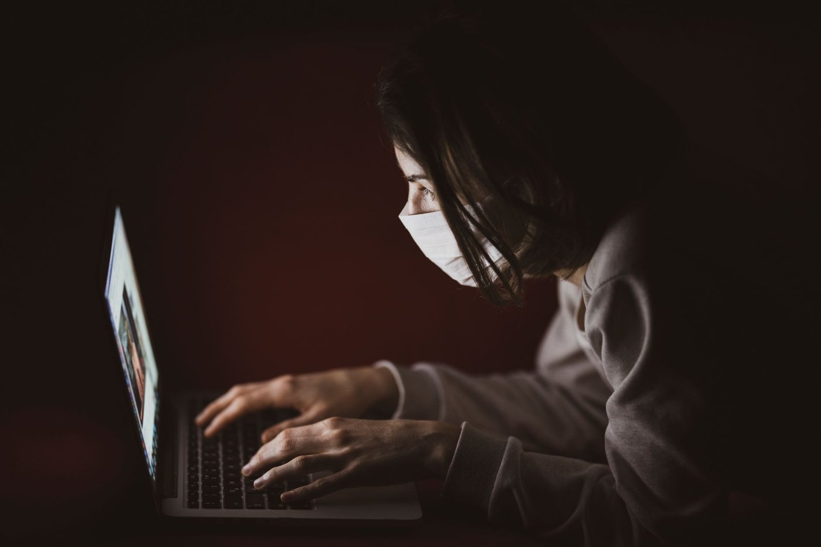 Adult woman reviewing an online profile on a laptop in a private London setting