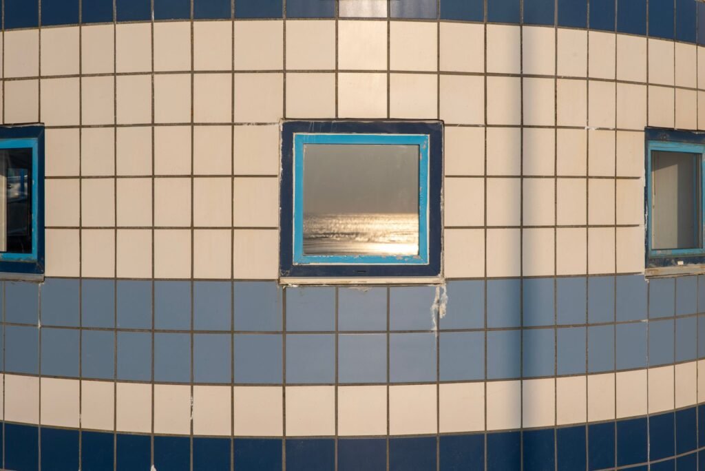 Minimalistic view of a tiled wall reflecting the ocean's shimmer.