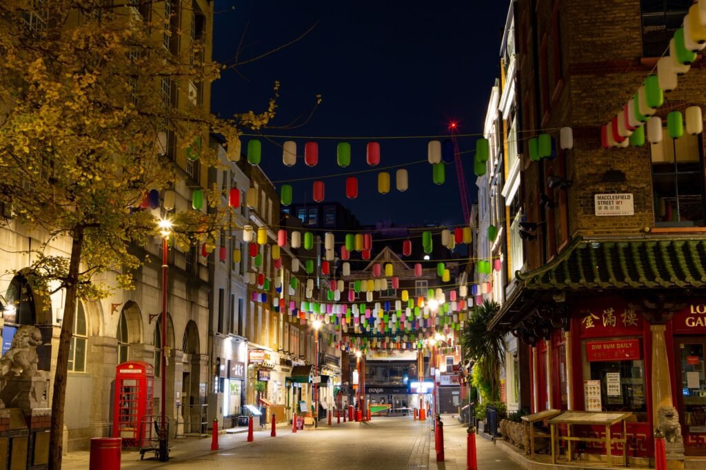 Colorful lanterns illuminate a Chinatown street, capturing a lively night scene.