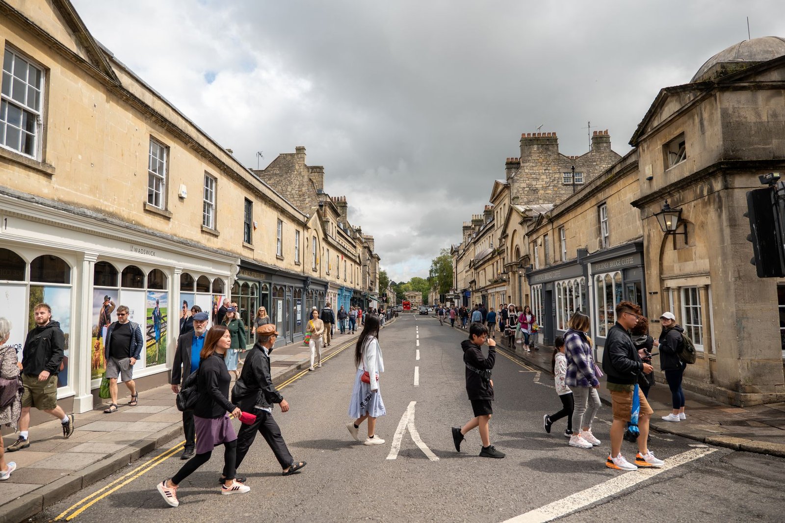 A visitor walking through a historic Bath street