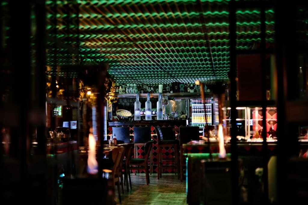 An inviting bar with glowing lights and vibrant decor, perfect for nightlife enthusiasts.