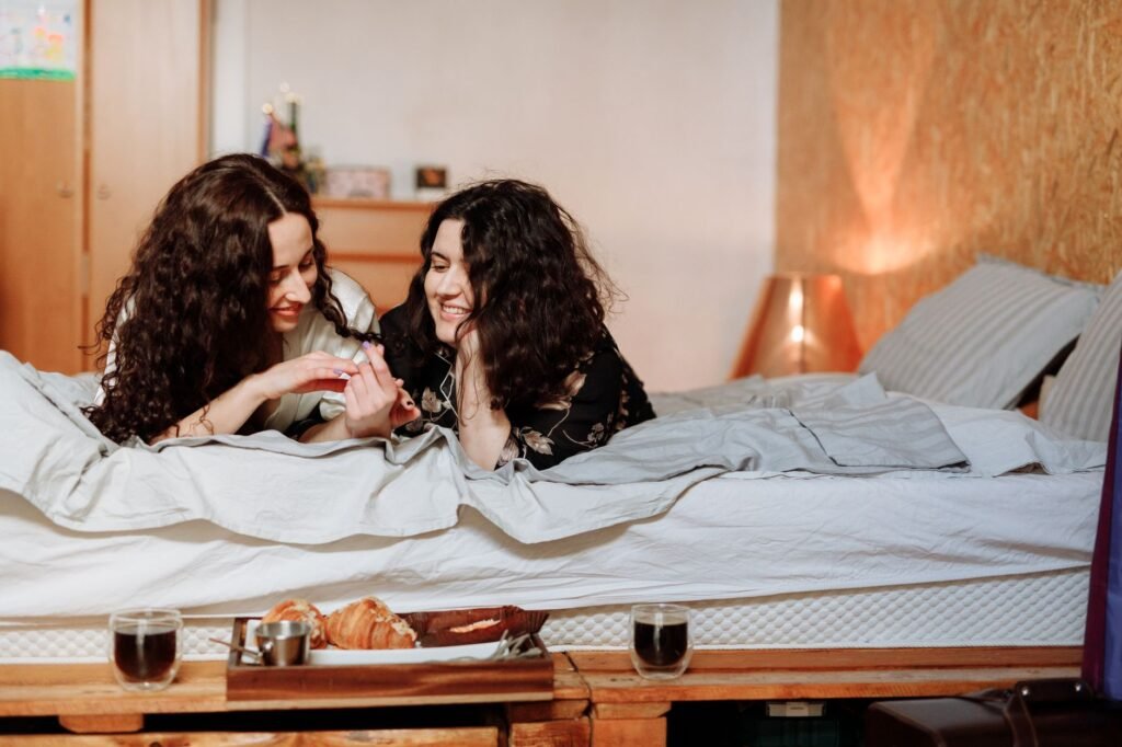 A joyful couple enjoys a cozy morning with breakfast in bed, exuding warmth and affection.