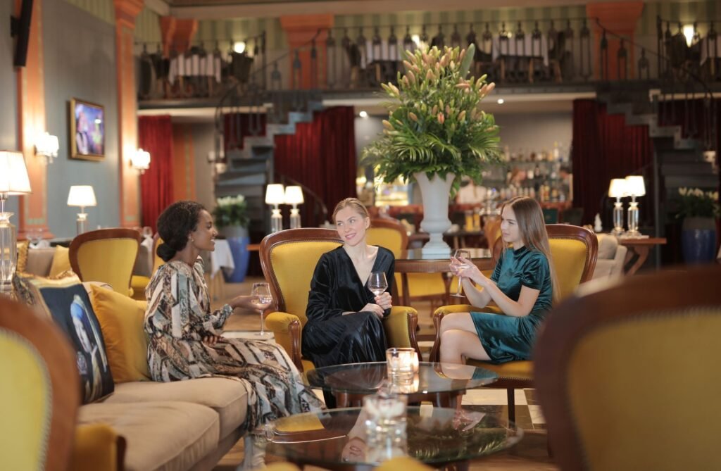 Two adults having a relaxed conversation in a Cambridge hotel lounge