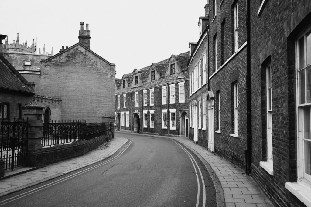Black and white photo of a historic street in King's Lynn, showcasing classic architecture.