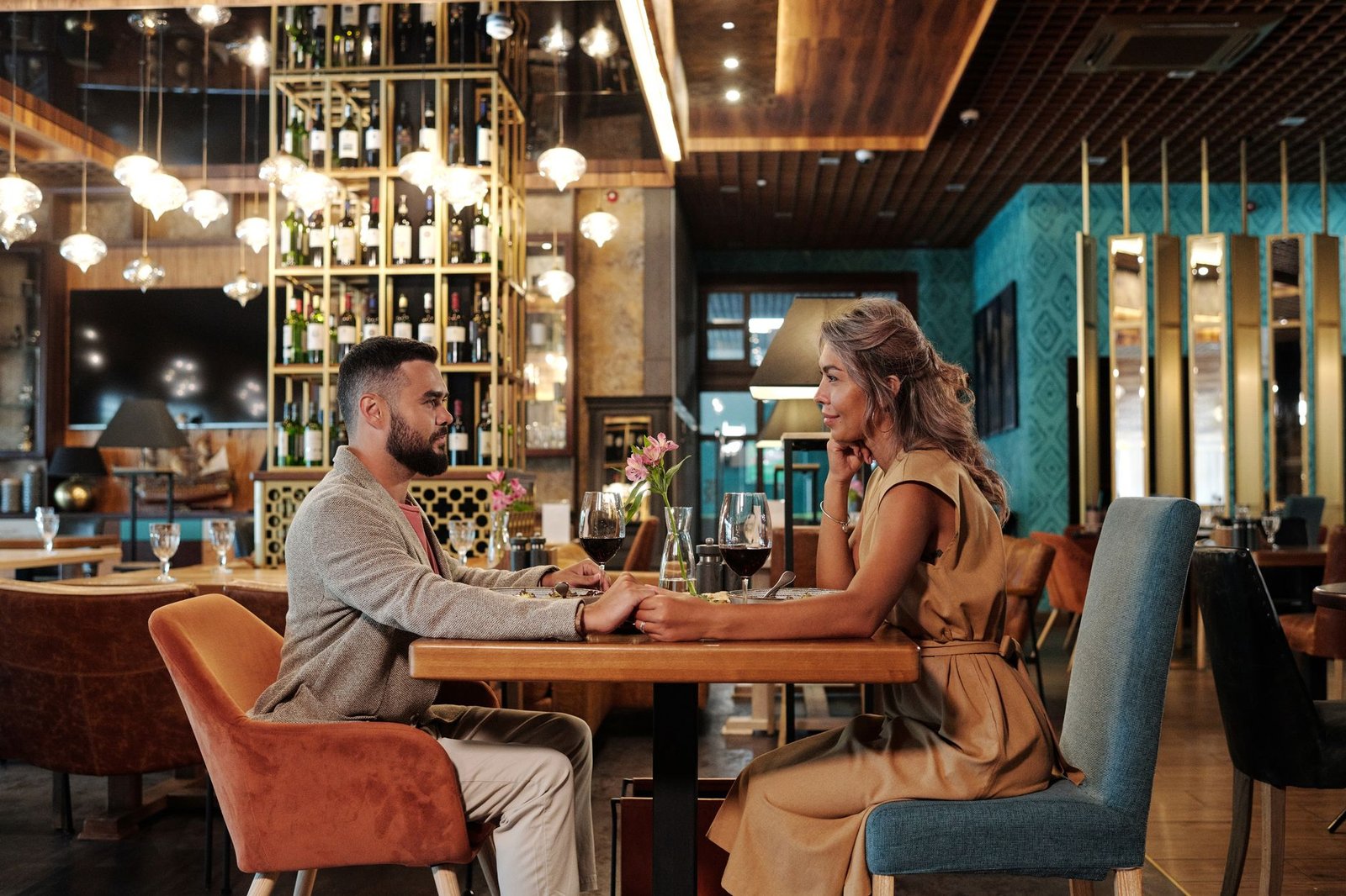 Couple enjoying a stylish dinner date in a warm modern setting