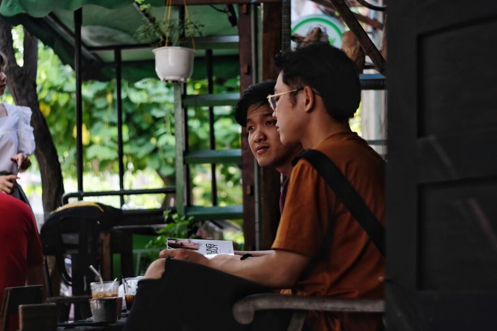Two adults discussing arrangements discreetly in a café