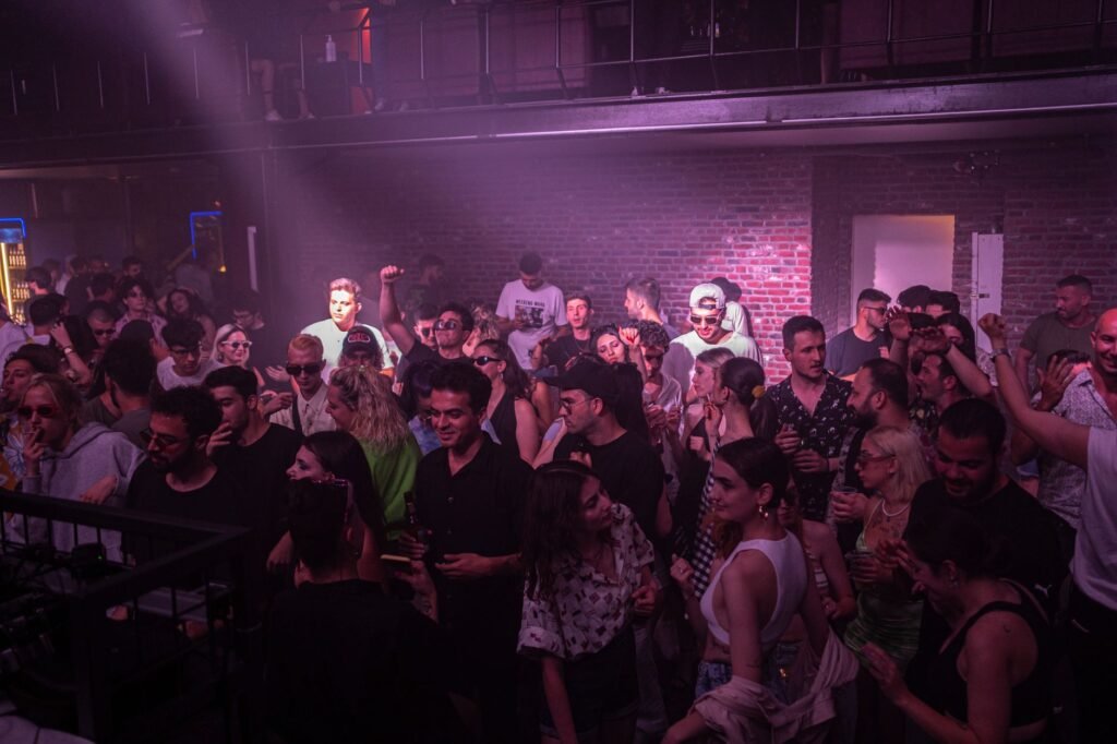 Energetic crowd dancing and enjoying music in a lively nightclub atmosphere.