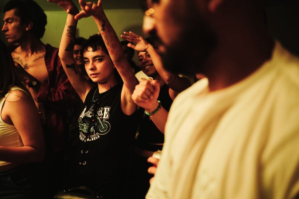 Energetic party scene with dancing and lively expressions in a Mexican nightclub.