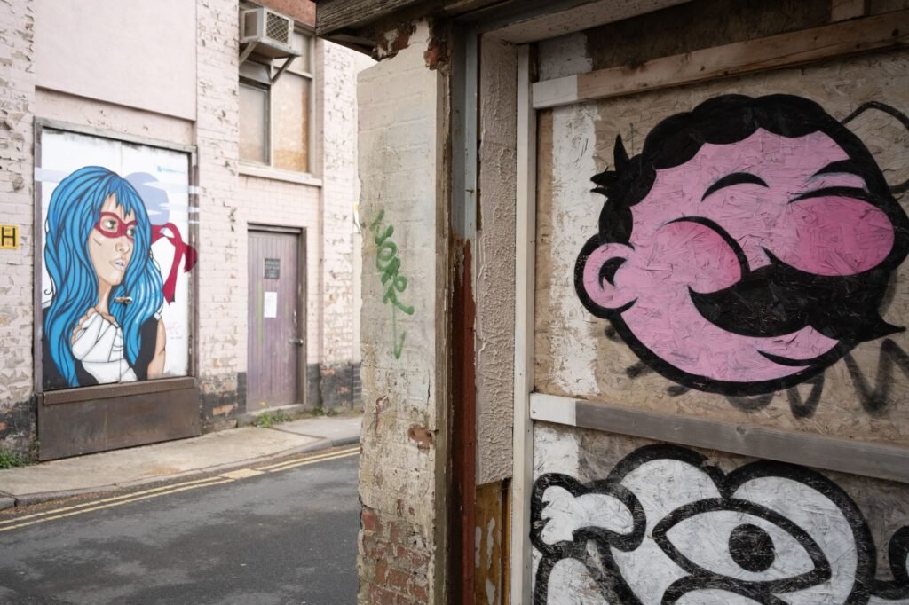 Vibrant street art featuring bold graffiti and murals in Swindon, England.