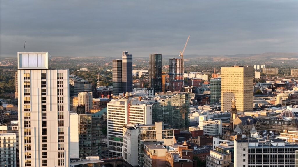 Stunning aerial view of Manchester's modern skyline with skyscrapers and urban landscape.