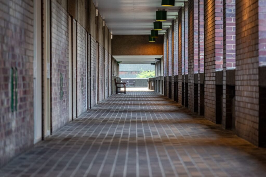 Well-lit walkway near Crawley transport links after dusk