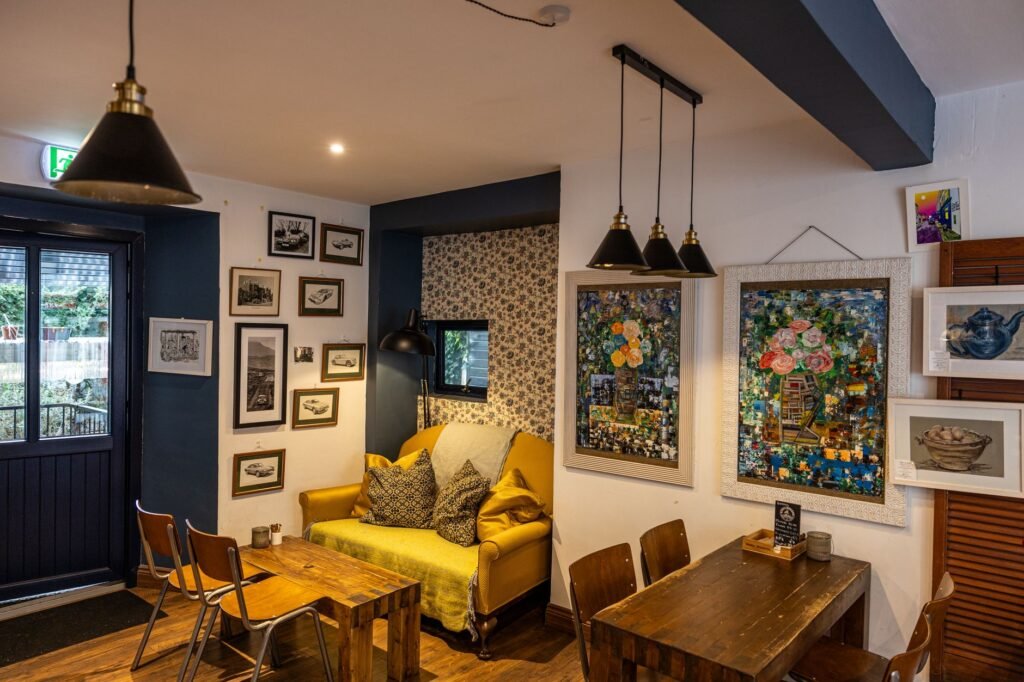 Charming café interior with vintage décor and art-lined walls in Kinsale, Ireland.