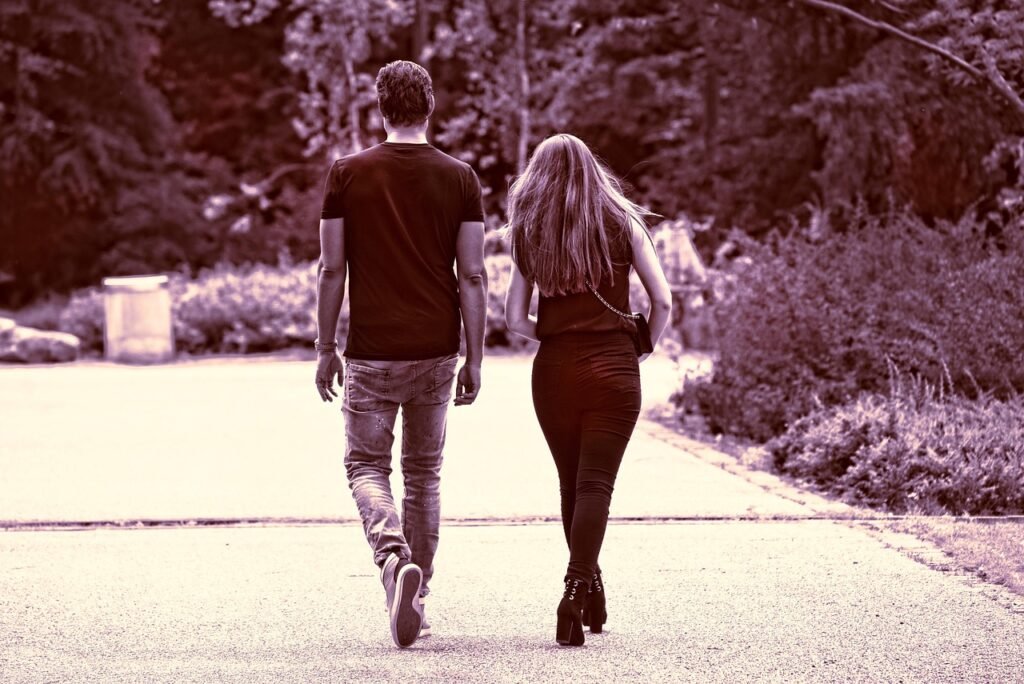 person, people, woman, man, couple, two, together, side by side, walking, activity, motion, back view, from behind, editorial