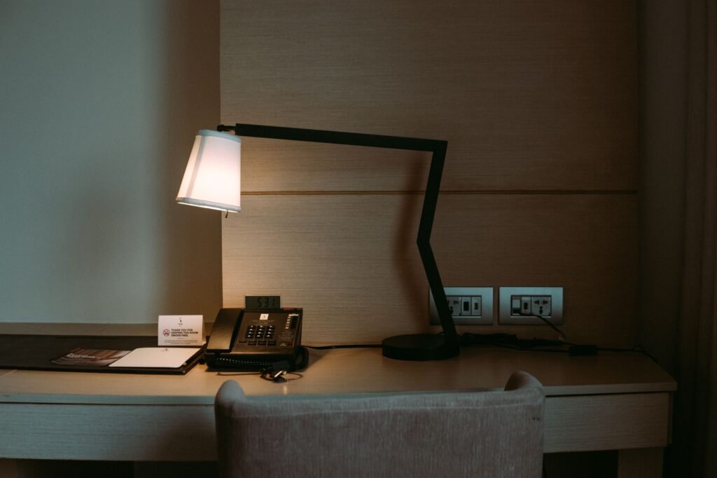 Visitor checking travel and booking notes in a Dundee hotel room