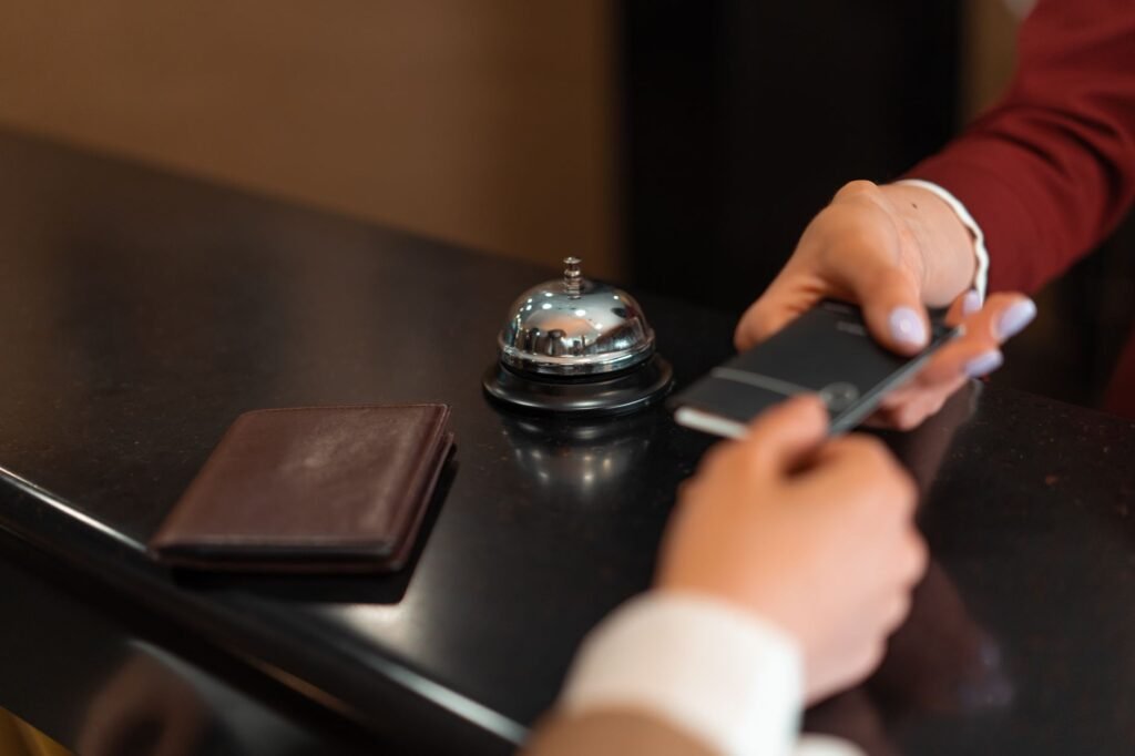 Travel planning notes and smartphone on a hotel desk
