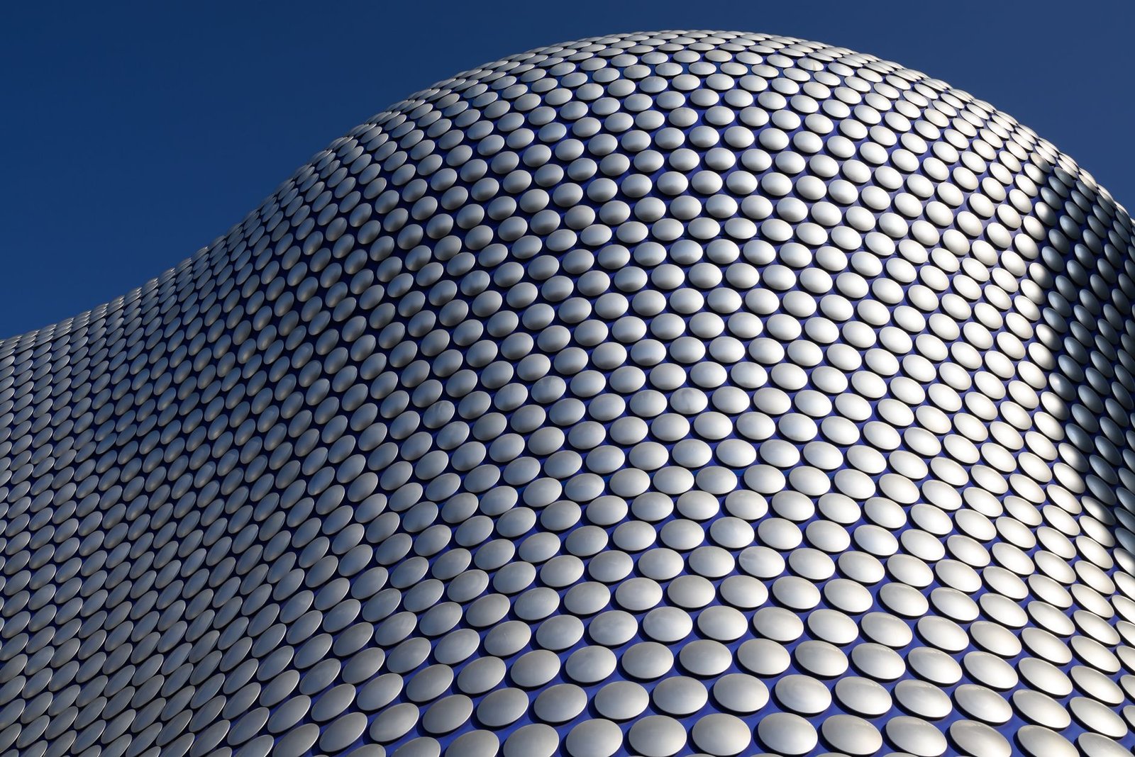 Modern abstract view of Bullring's circular facade. Iconic Birmingham architecture.