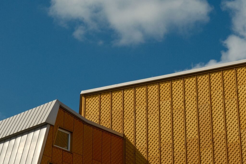 A modern building with geometric patterns and a vibrant blue sky background, showcasing contemporary architecture.