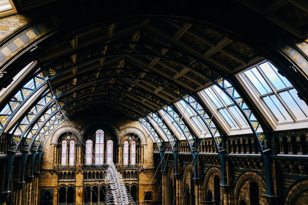 Stunning view of the Victorian-style interior of the Natural History Museum in London featuring intricate architecture and a