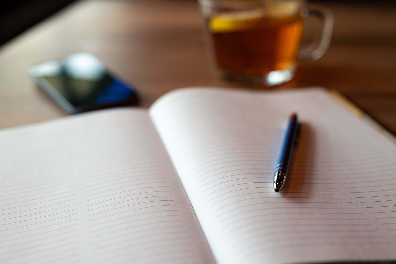 Notebook and phone on a quiet café table used for discreet appointment planning