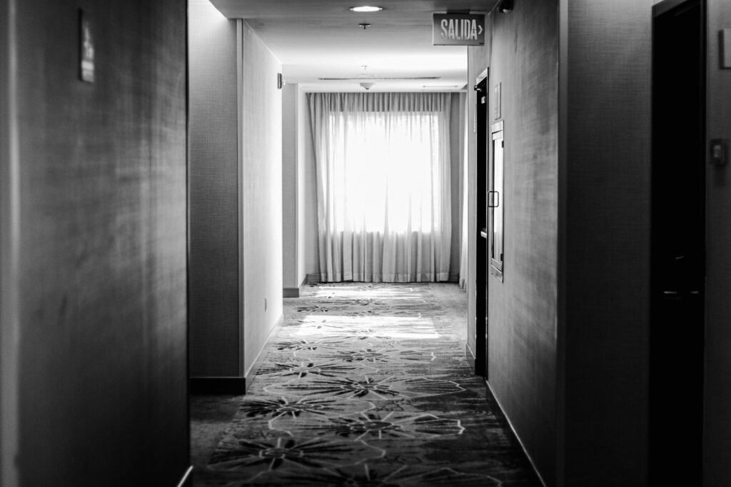 A quiet hotel corridor with clear access to an exit