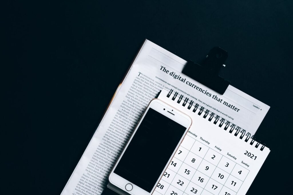 Writing an appointment time beside a smartphone