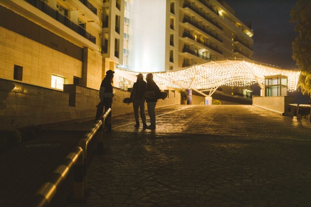 A discreet hotel entrance at dusk representing careful travel and privacy planning