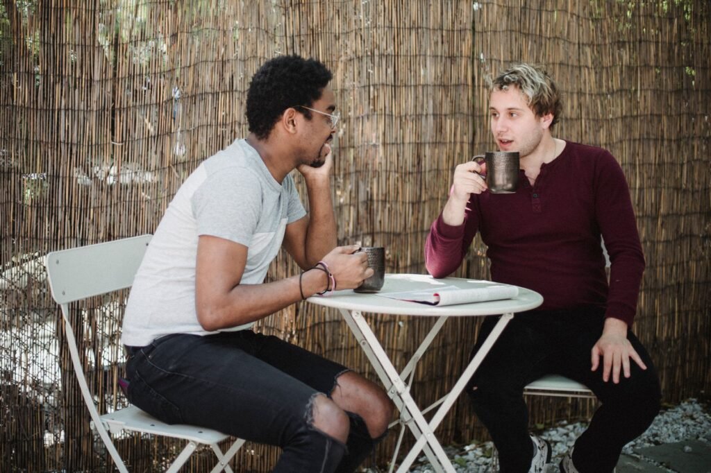 Two adults having a respectful conversation in a private lounge