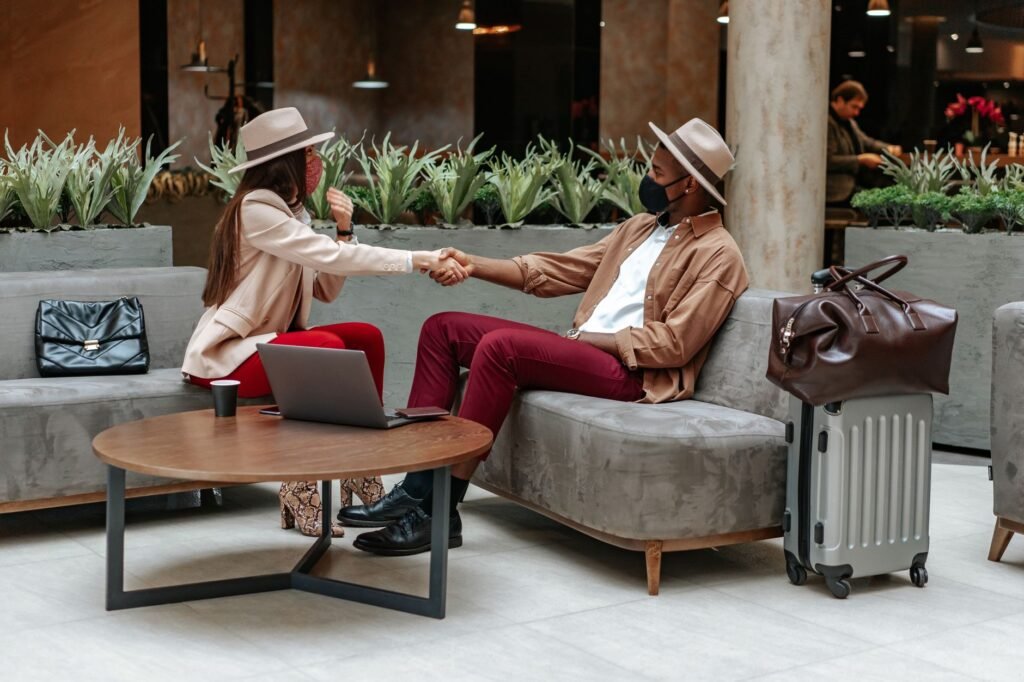 A traveller checking a phone and time before meeting in a hotel