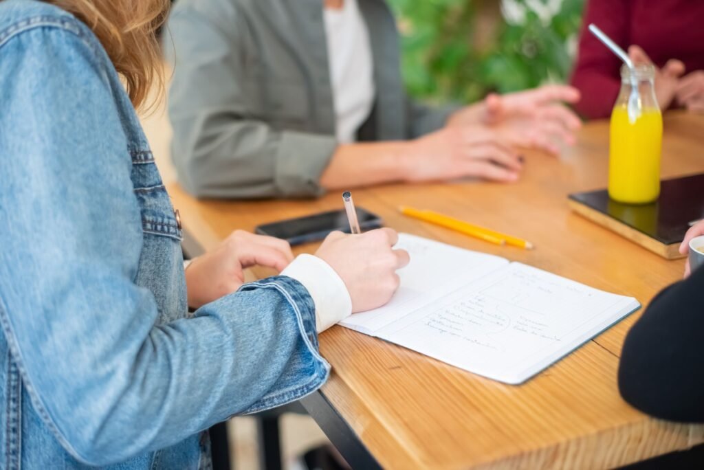 Two adults discussing arrangements discreetly at a café table