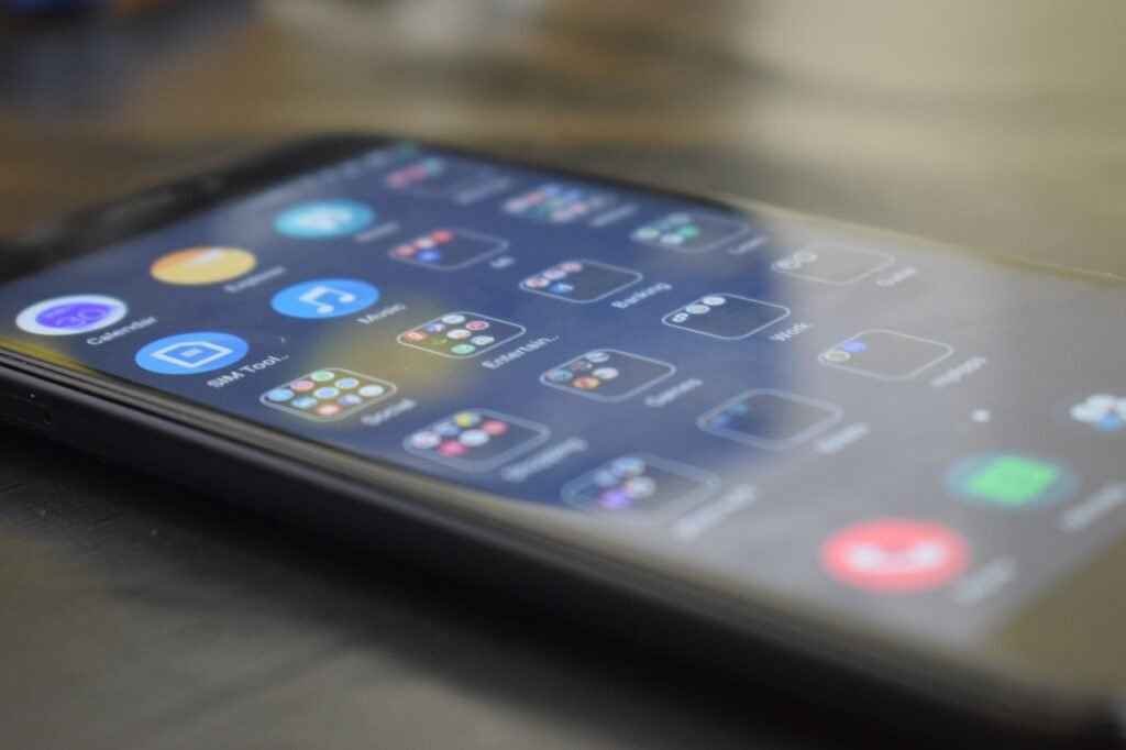 Person checking booking details on a smartphone beside a calendar