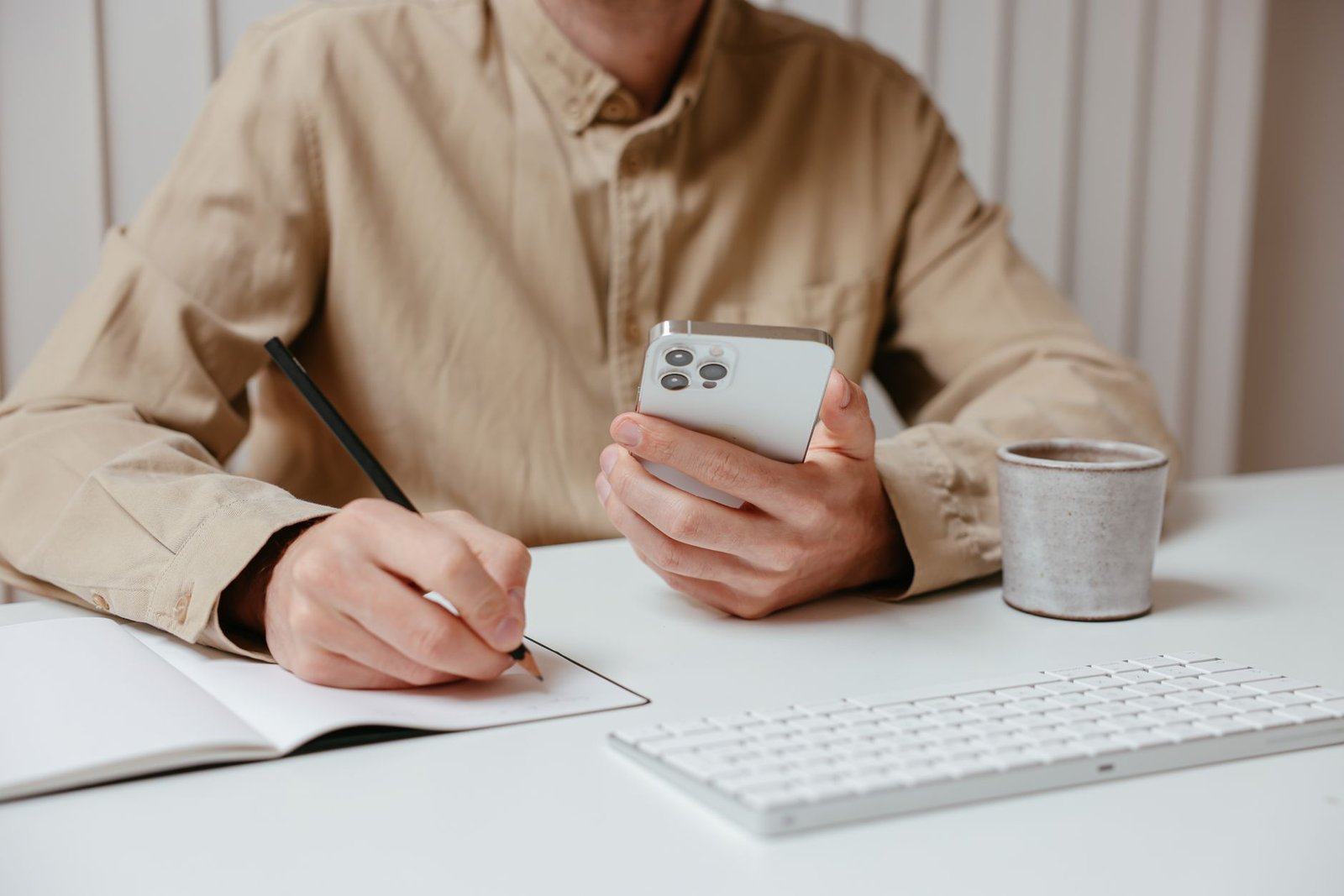 Smartphone and notebook prepared for discreet travel planning in Lisburn