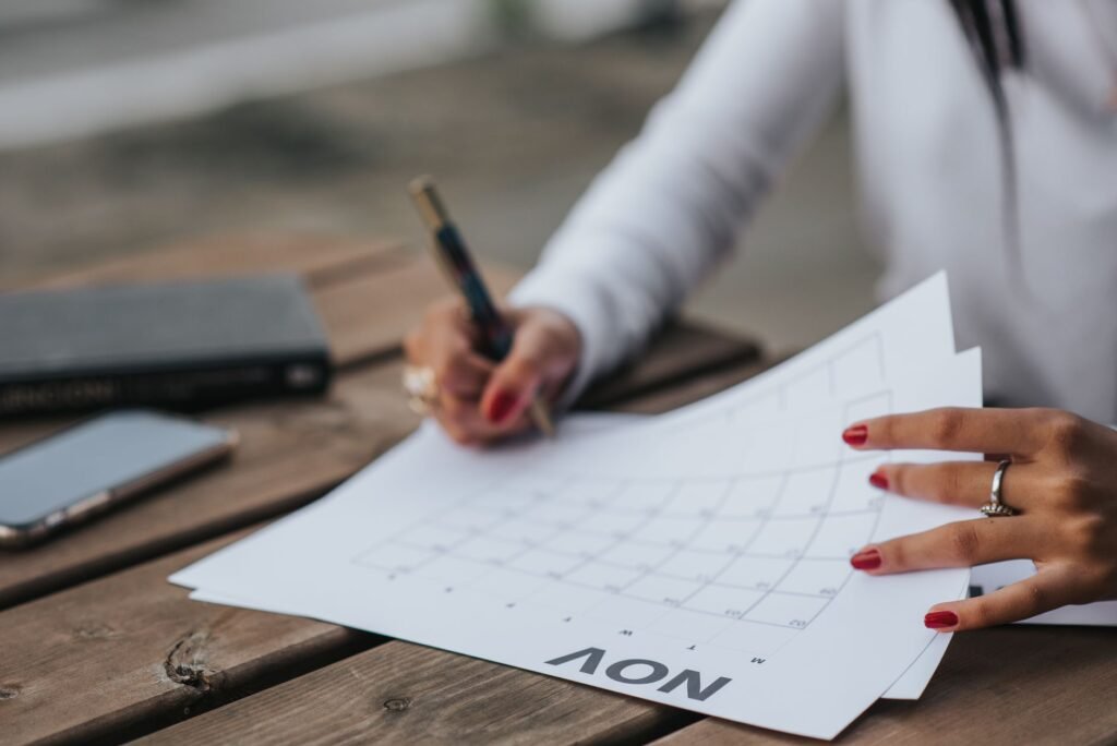Writing appointment details beside a smartphone