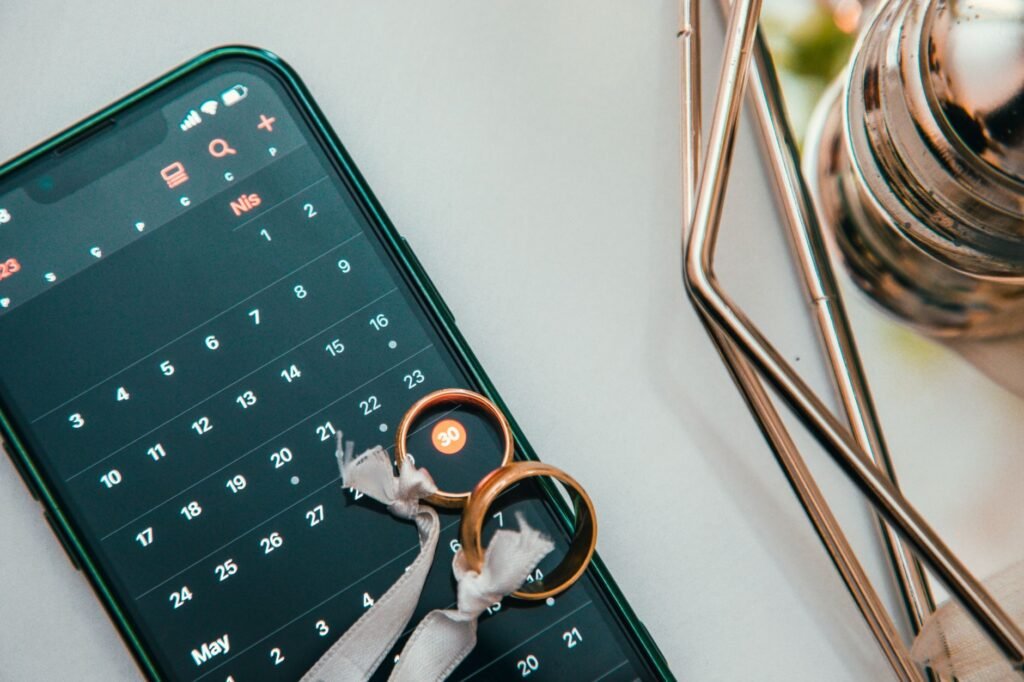 A phone calendar reminder beside keys and a coat