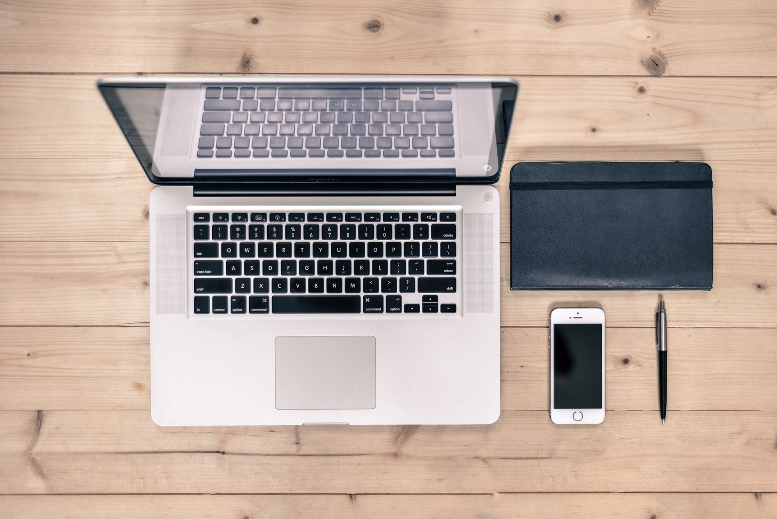 A discreet booking-planning desk with a smartphone and notebook in Manchester