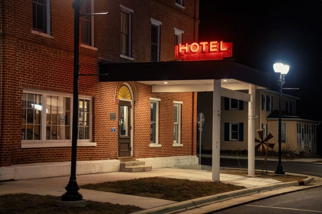 Traveller checking a phone near a discreet hotel entrance