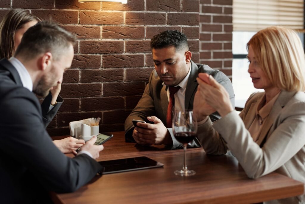Adults discussing appointment details discreetly at a café