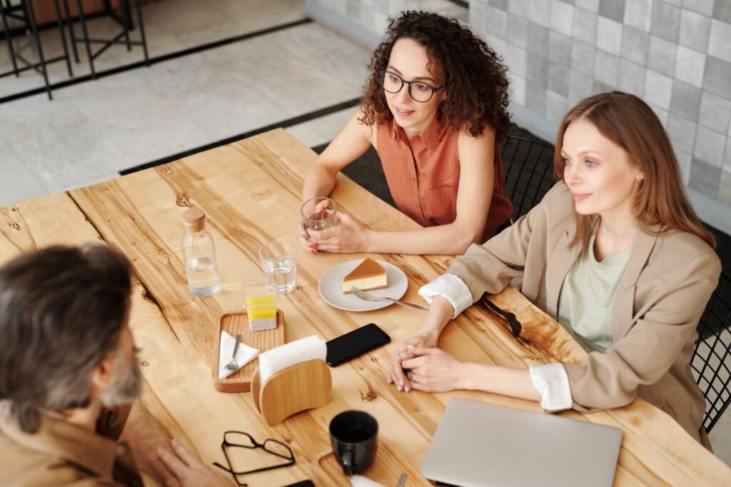 Two adults having a respectful conversation in a café