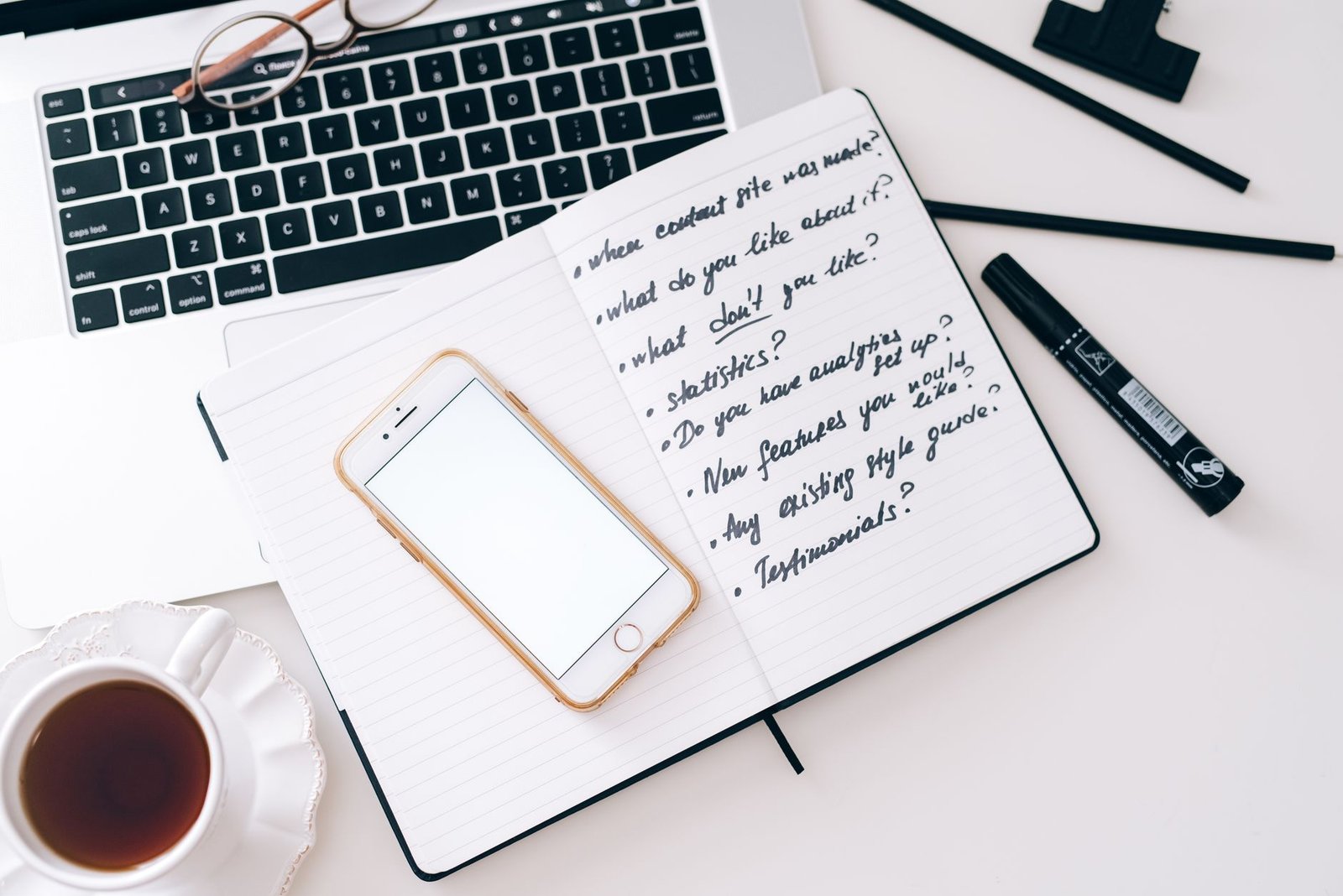 A smartphone and notebook on a discreet hotel desk