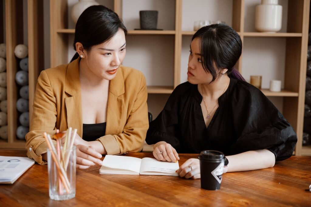 Two adults discussing arrangements respectfully at a café table