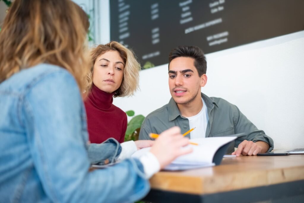 Two adults discussing booking details respectfully