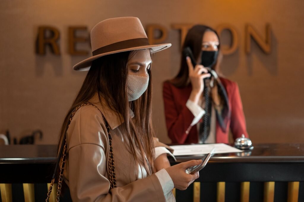 Traveller checking arrival details outside a hotel
