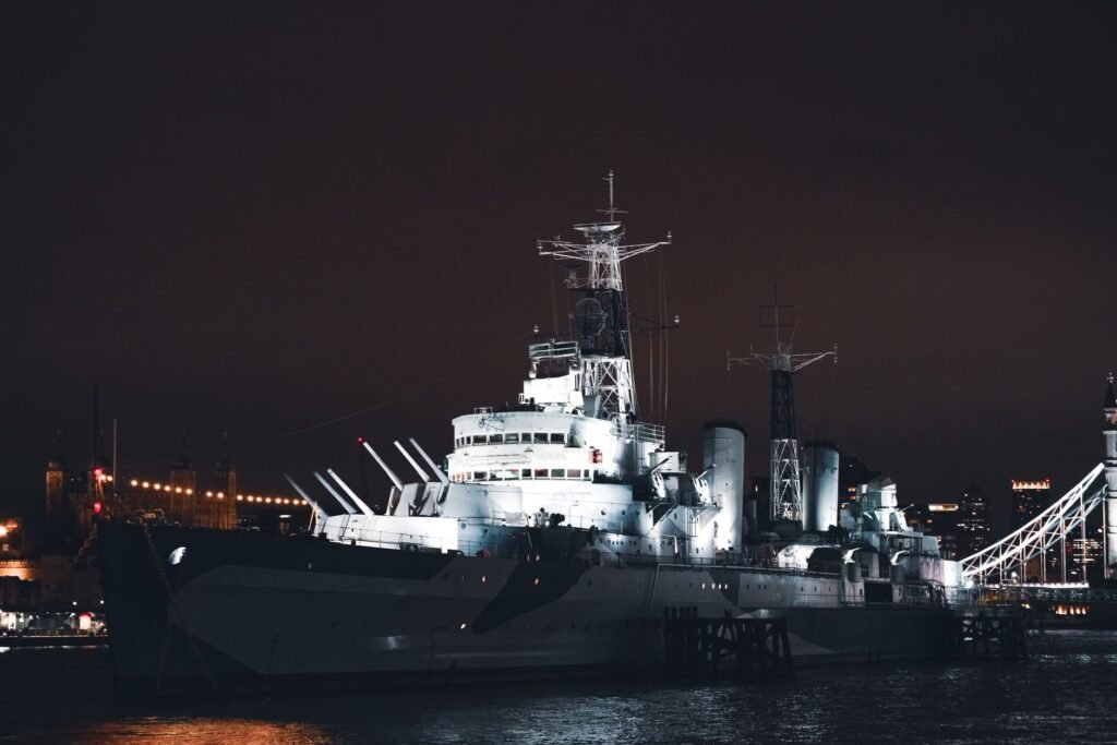 A stunning night view of HMS Belfast illuminated on the River Thames in London, United Kingdom.