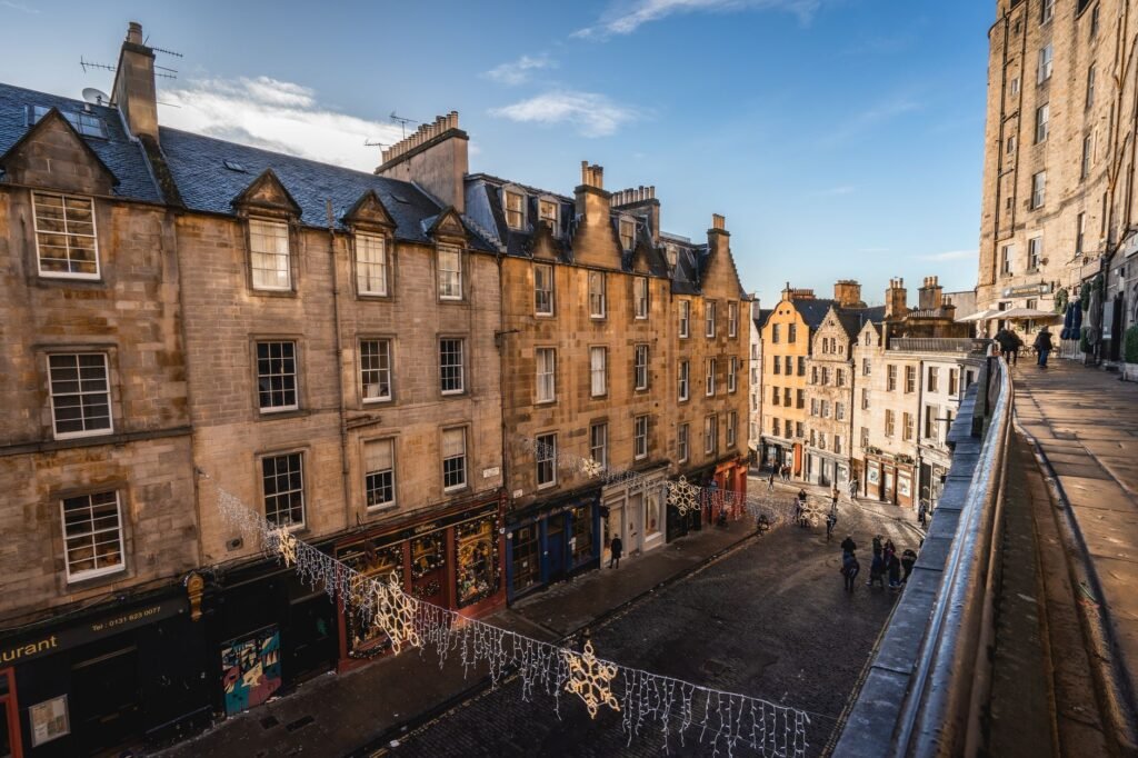 Explore the historic charm of Victoria Street, Edinburgh's iconic Old Town, under daylight.